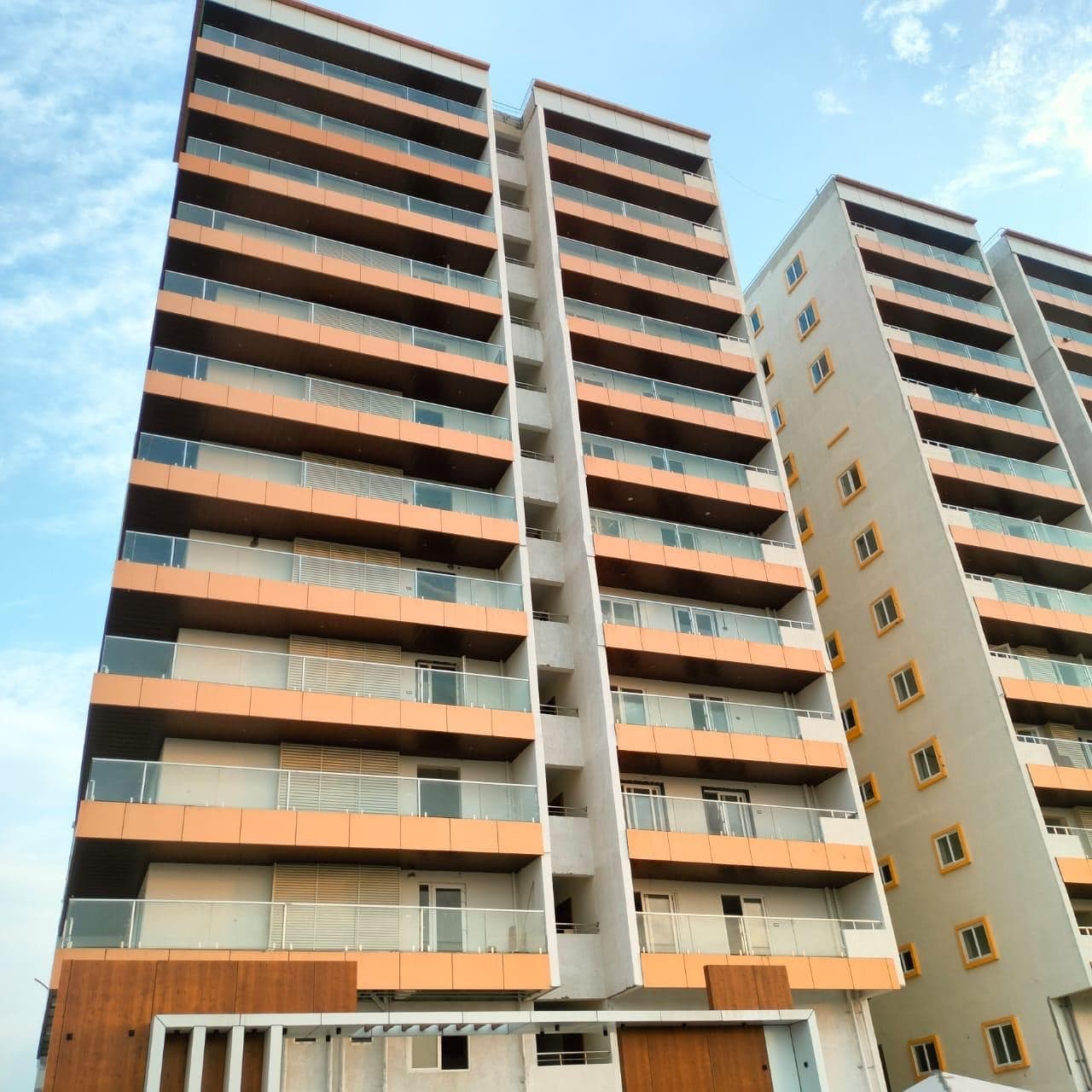 Sky-Tower Residency, a tall high-rise apartment tower with terracotta cladding bands and glazed balconies