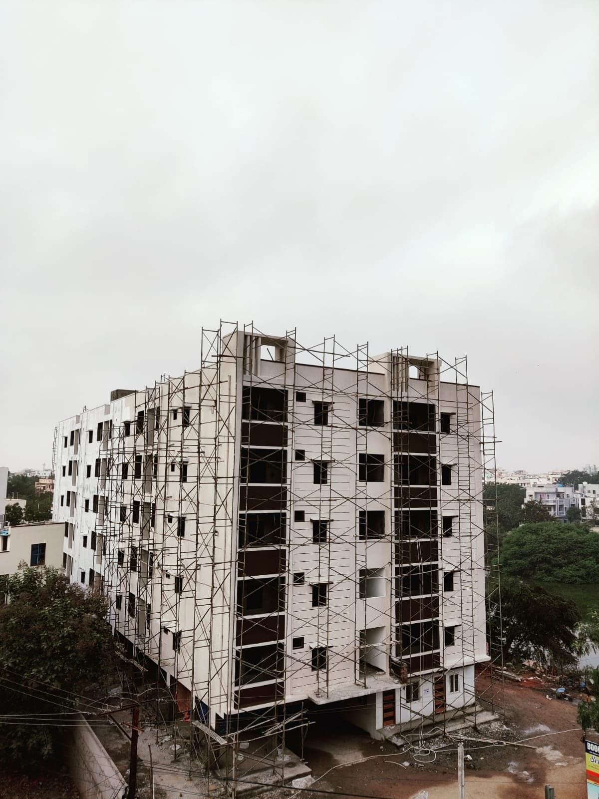 Srinivasam apartment building fully wrapped in bamboo scaffolding during plastering stage